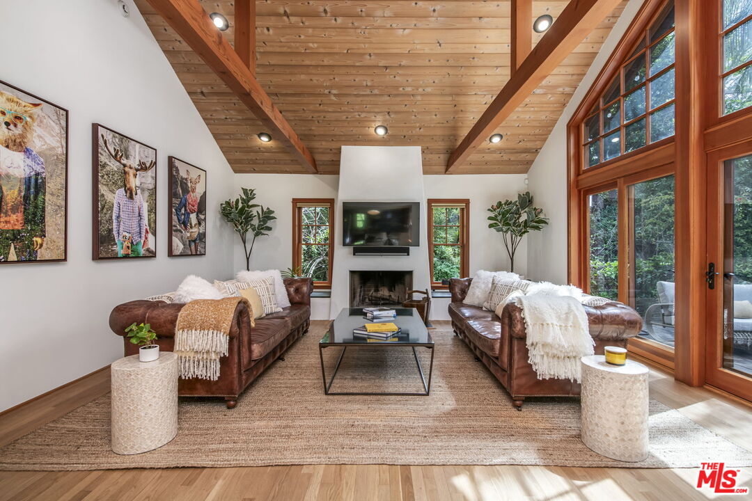 27 Latimer Road Santa Monica, CA 90402 - Photo 5 of 37 a living room with furniture fireplace and a large window