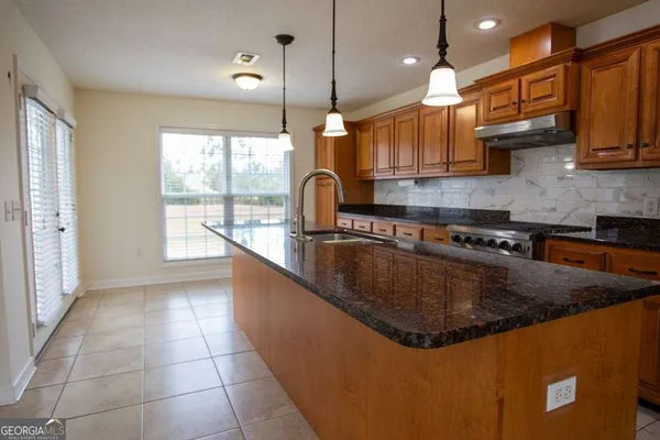 a kitchen with stainless steel appliances granite countertop a sink counter space cabinets and stainless steel appliances