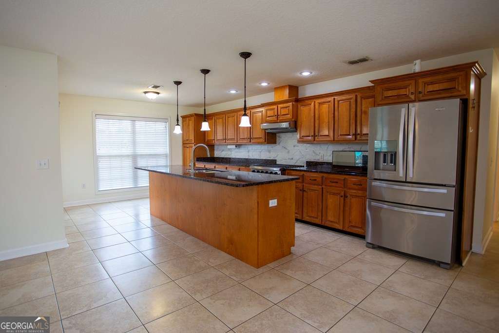 99 Jennifer Lane Baxley, GA 31513 - Photo 20 of 48 a kitchen with stainless steel appliances granite countertop a sink counter space cabinets and stainless steel appliances