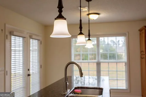 a white refrigerator freezer and a stove sitting inside of a kitchen