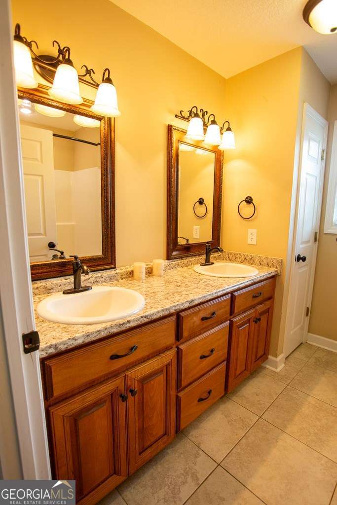 99 Jennifer Lane Baxley, GA 31513 - Photo 33 of 48 a bathroom with a granite countertop sink mirror and a