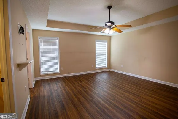 a view of a livingroom with wooden floor and window