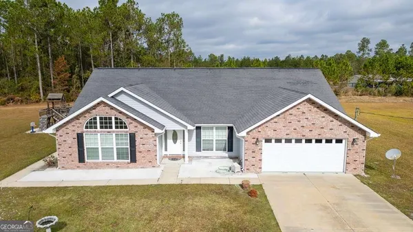 a front view of a house with a yard