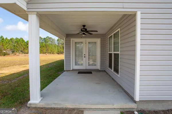a view of a porch with wooden floor and a ceiling fan