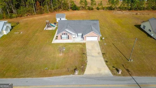 an aerial view of a house with a yard