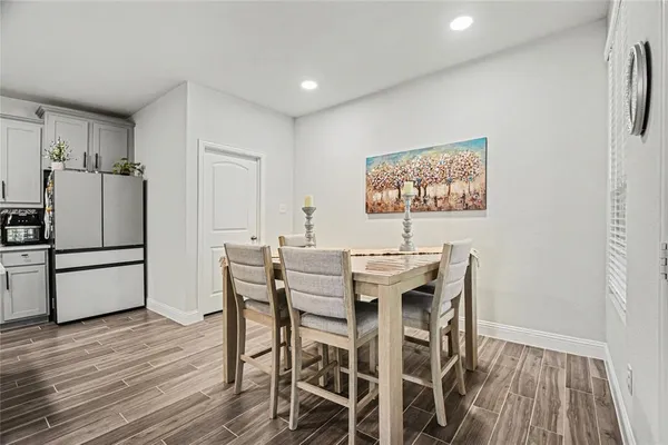a view of a dining room with furniture and wooden floor