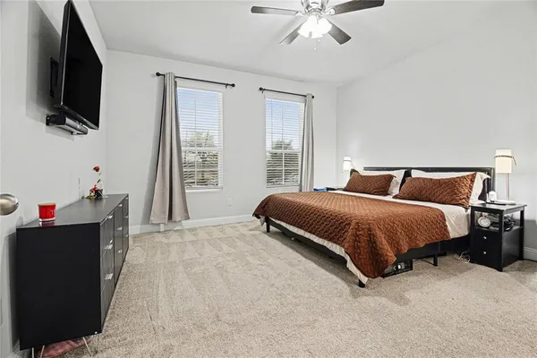 a bedroom with a bed and flat screen tv