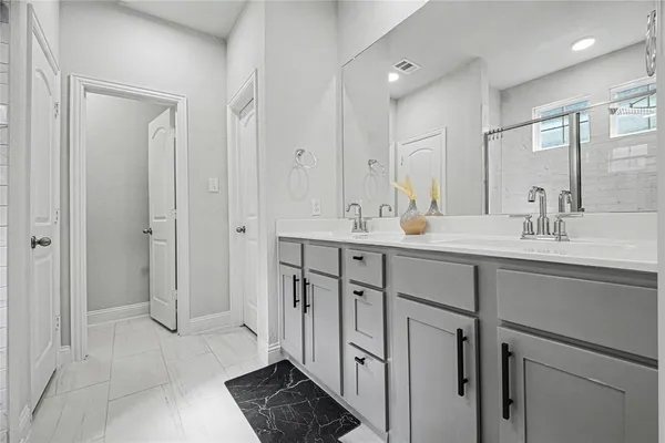 a bathroom with a sink double vanity and a mirror