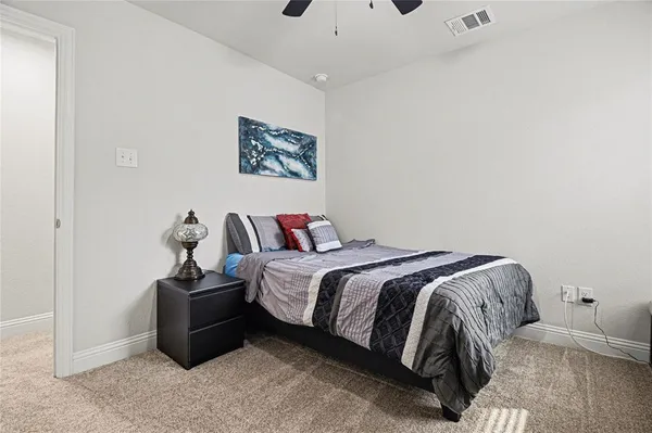 a bed room with a bed and a chair