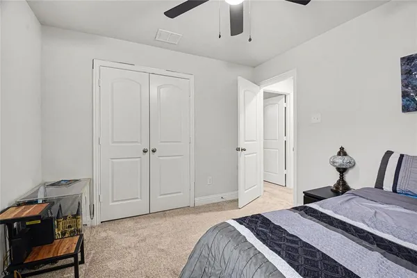 a bedroom with a bed and a tv