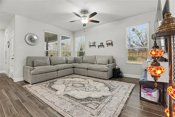a living room with furniture and a chandelier