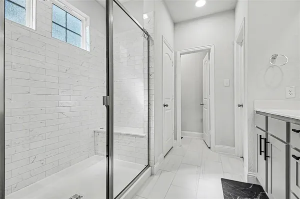 a bathroom with a glass shower door