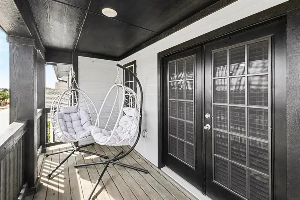 a view of a door and chair in wooden floor