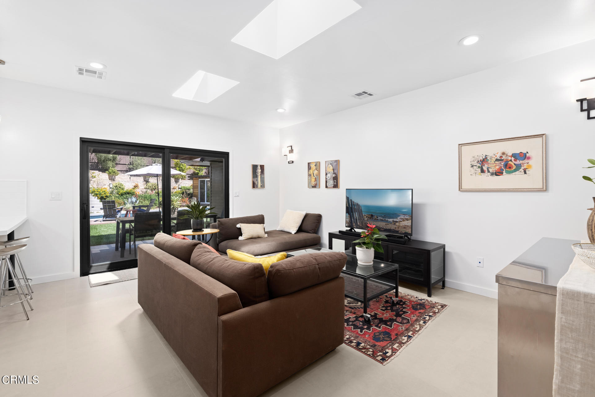 316 Glenullen Drive Pasadena, CA 91105 - Photo 11 of 43 a living room with furniture and a flat screen tv