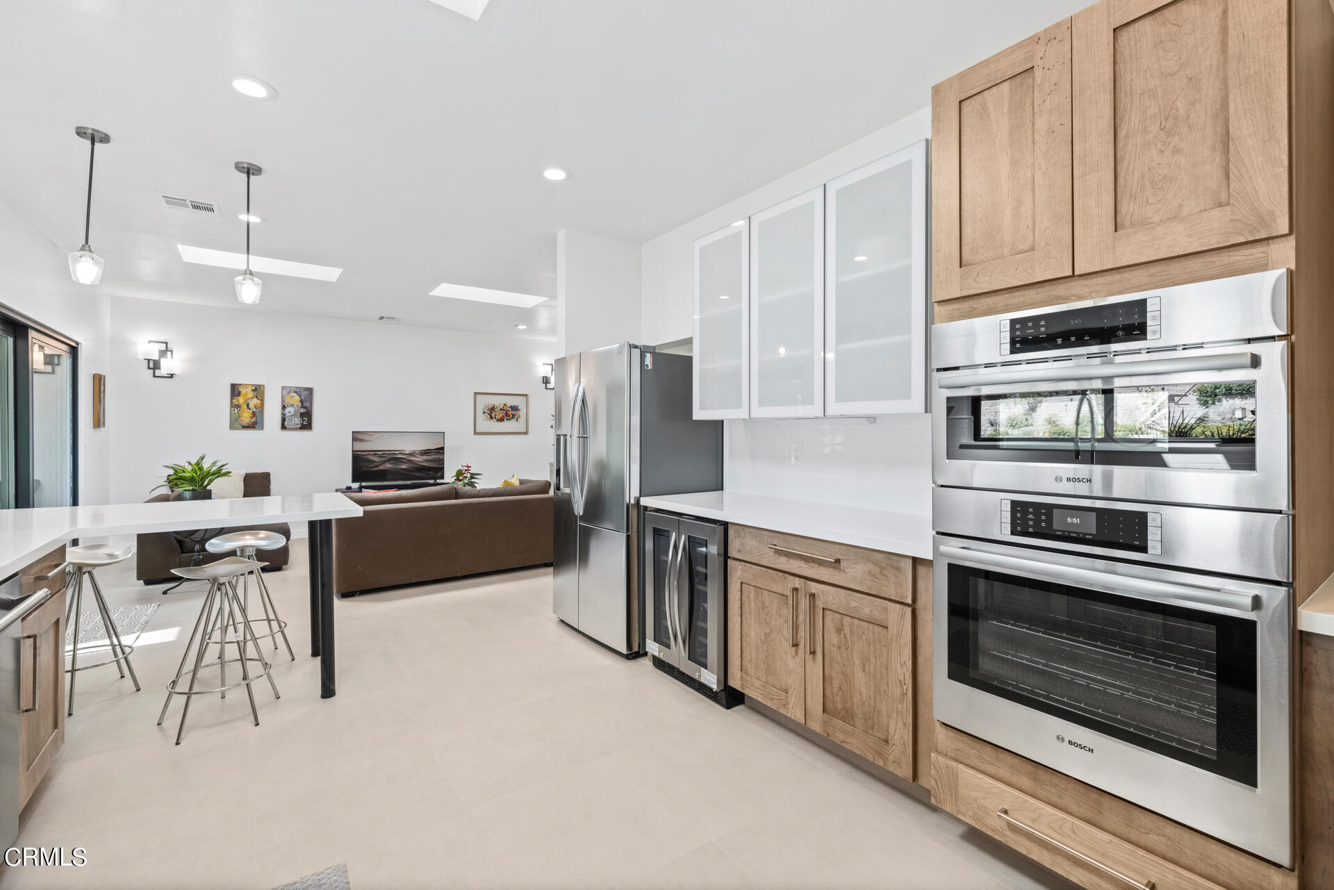 316 Glenullen Drive Pasadena, CA 91105 - Photo 15 of 43 a kitchen with stainless steel appliances kitchen island granite countertop a stove top oven a sink dishwasher a refrigerator and white cabinets with wooden floor