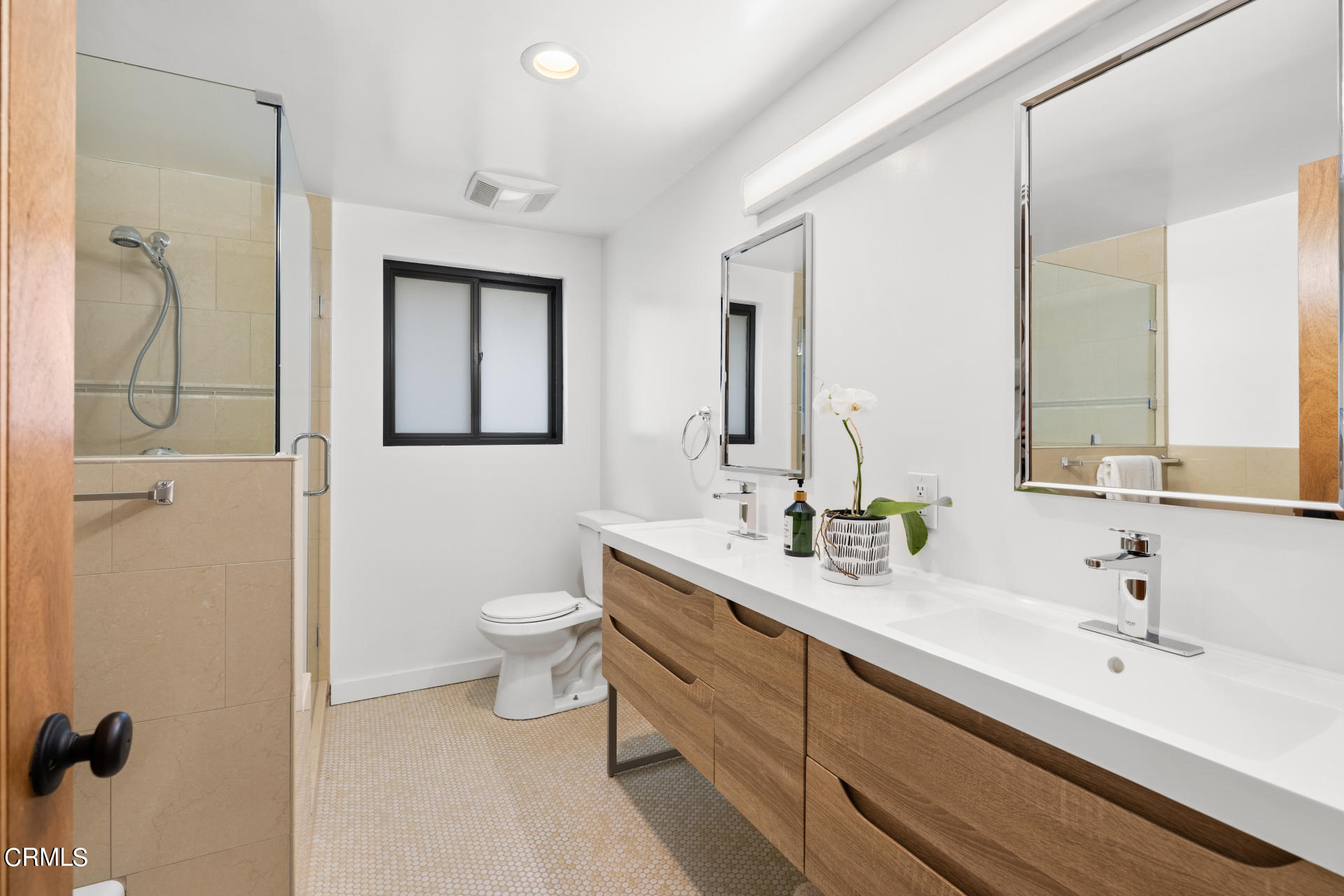 316 Glenullen Drive Pasadena, CA 91105 - Photo 20 of 43 a spacious bathroom with a double vanity sink toilet mirror and shower