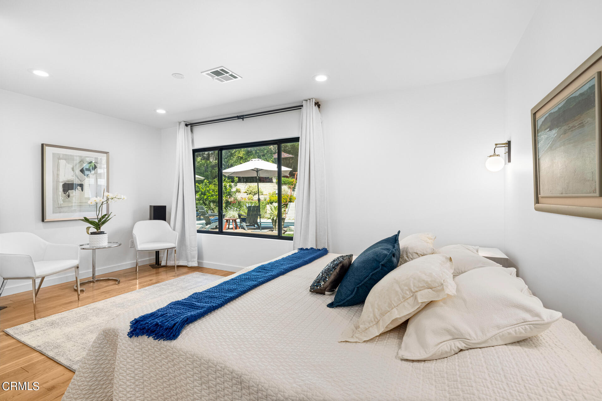 316 Glenullen Drive Pasadena, CA 91105 - Photo 23 of 43 a bedroom with a large bed and a chandelier