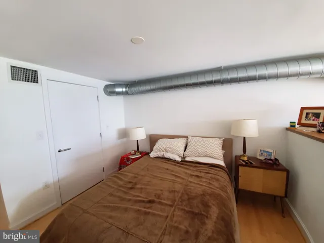 a bedroom with a bed and a night stand