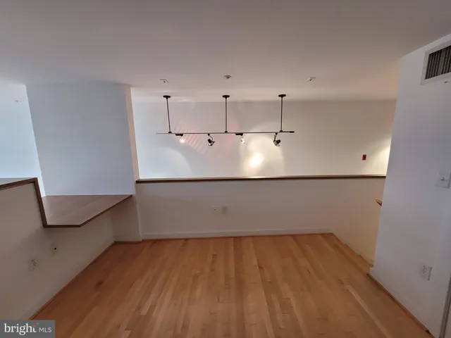 a view of a room with wooden floor and cabinet