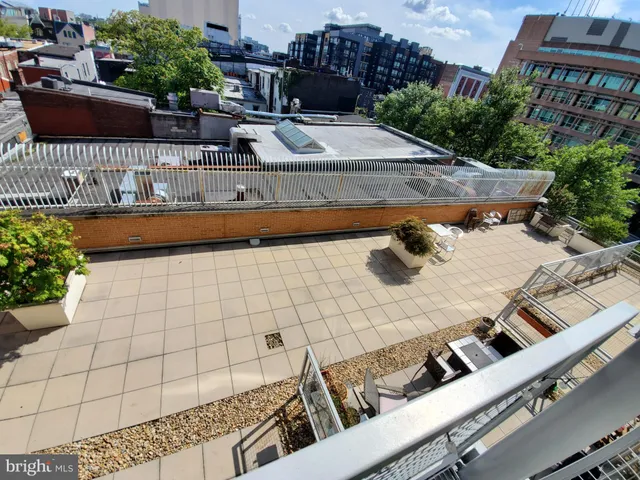 a view of a terrace with chairs and potted plants