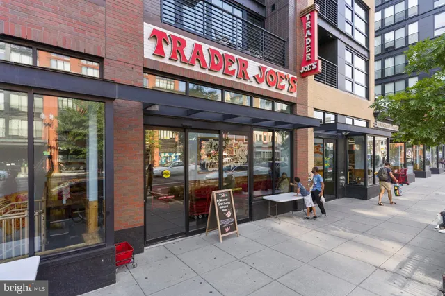 a front view of a building with plants