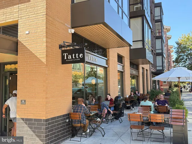 a group of people sitting in front of retail shop
