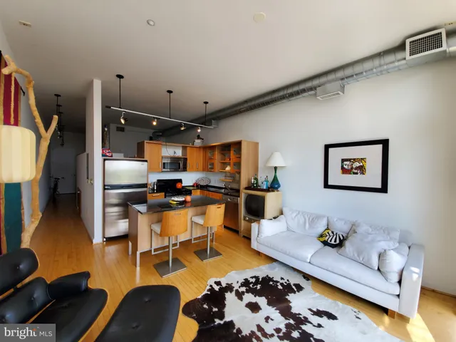 a living room with lots of furniture and kitchen view