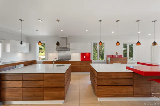 a kitchen with stainless steel appliances kitchen island granite countertop a table chairs in it and wooden floors