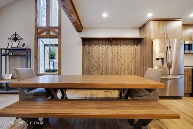 a living room with a table or chairs and a kitchen