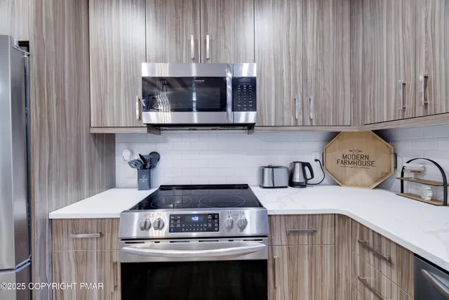 a kitchen with a stove and cabinets