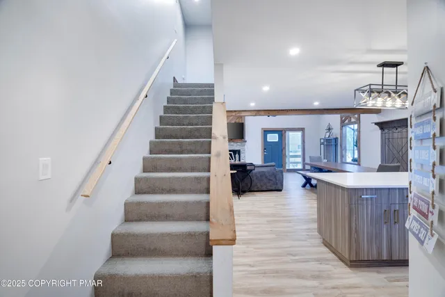 a view of hallway with livingroom and furniture