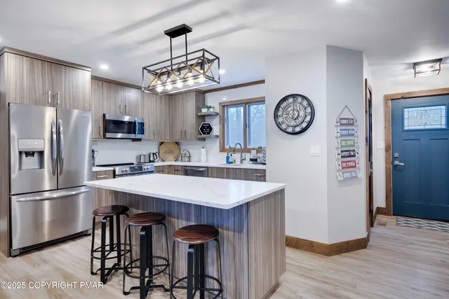 a kitchen with a table and a refrigerator
