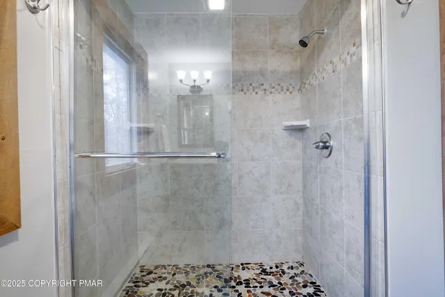 a bathroom with a sink a mirror and a shower