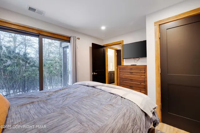 a bedroom with two beds and a couch