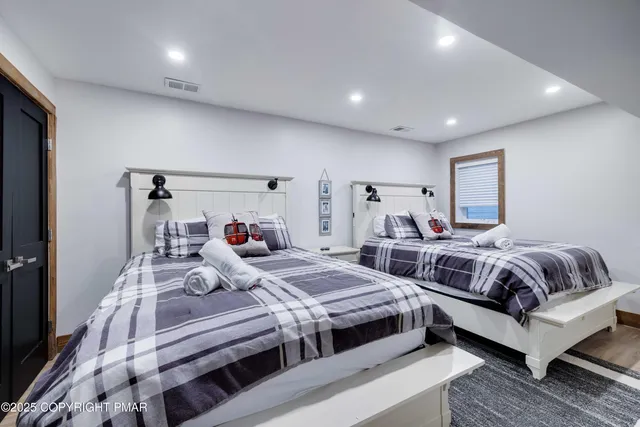 a bedroom with two beds and a couch