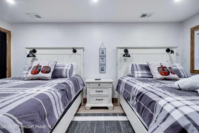 a view of a livingroom with wooden floor and a flat screen tv