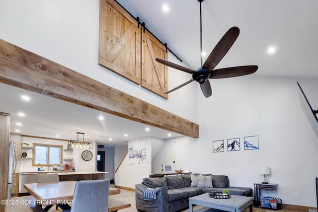 a living room with furniture and a ceiling fan