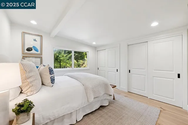 a bedroom with a large bed and a window