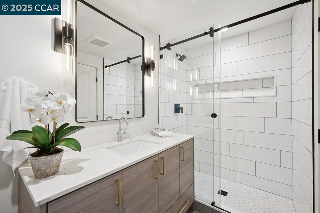 26 Berkeley Avenue Orinda, CA 94563 - Photo 17 of 28 a bathroom with a shower sink and mirror