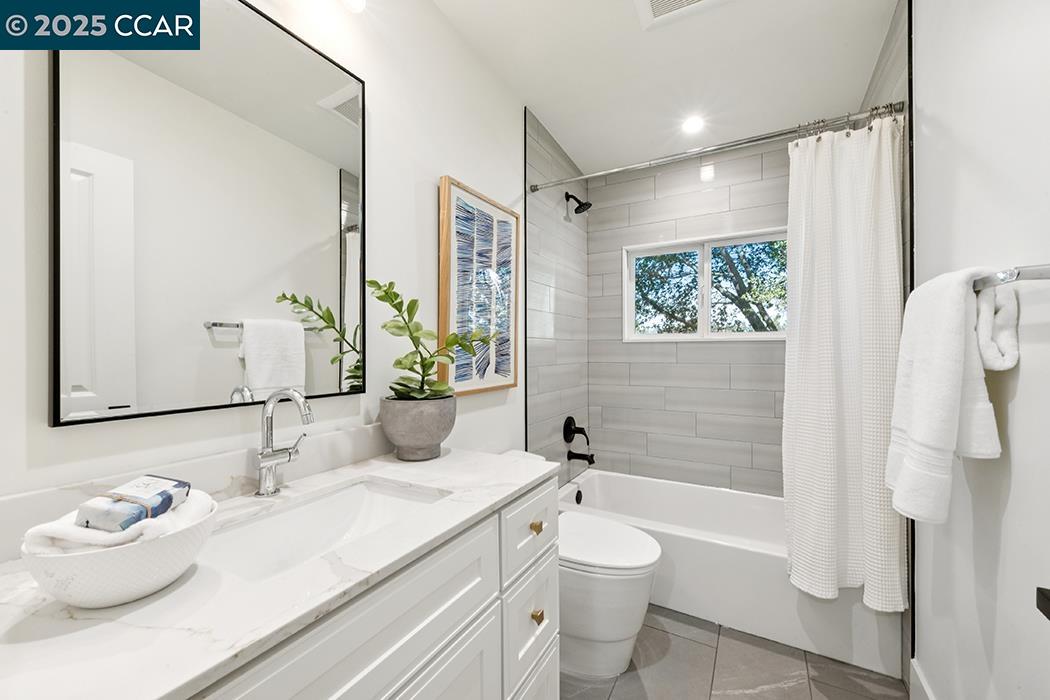 26 Berkeley Avenue Orinda, CA 94563 - Photo 19 of 28 a bathroom with a granite countertop sink and a mirror
