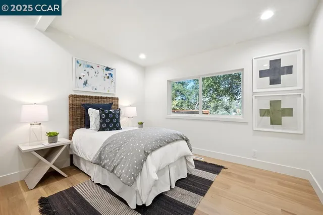 a bedroom with a large bed and a window