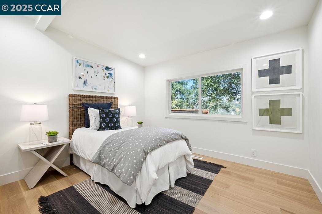 26 Berkeley Avenue Orinda, CA 94563 - Photo 20 of 28 a bedroom with a large bed and a window