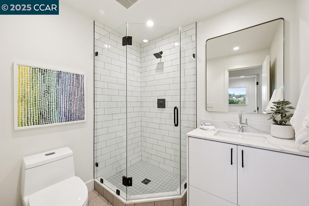 26 Berkeley Avenue Orinda, CA 94563 - Photo 26 of 28 a bathroom with a shower a sink and a mirror