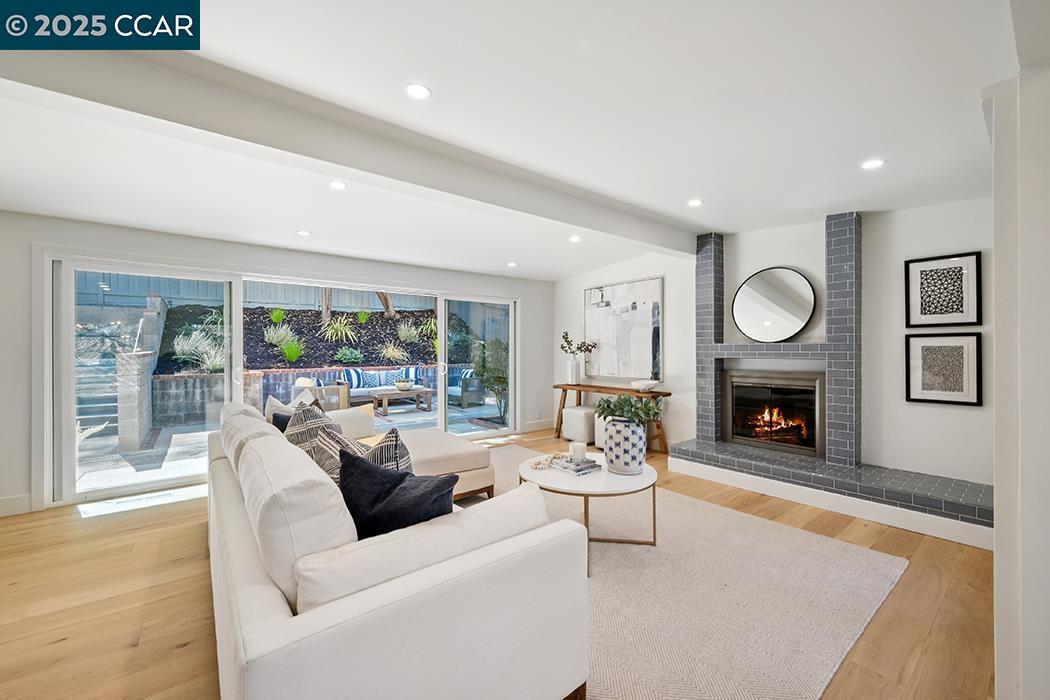 26 Berkeley Avenue Orinda, CA 94563 - Photo 4 of 28 a living room with furniture a fireplace and a large window