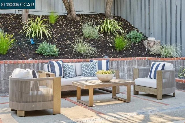 a outdoor living space with furniture and potted plants
