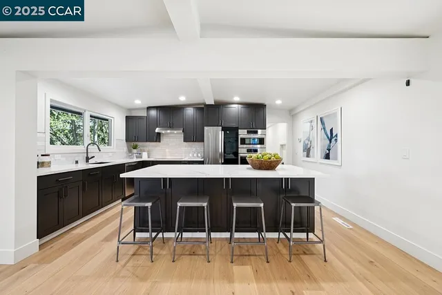 a kitchen with a table and chairs in it