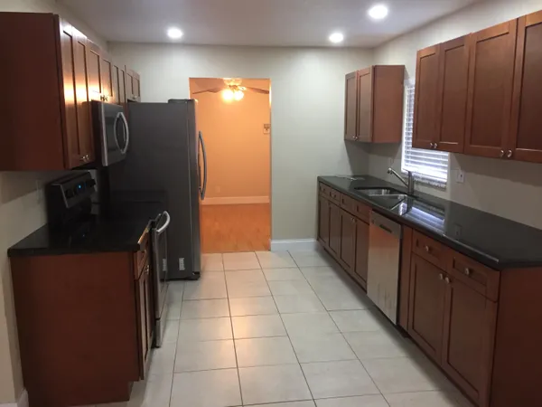 a kitchen with stainless steel appliances granite countertop a refrigerator and a stove