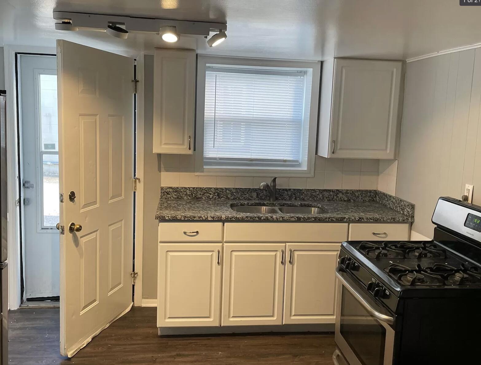 140 North West Street Crown Point, IN 46307 - Photo 5 of 15 a kitchen with granite countertop a sink stove and cabinets