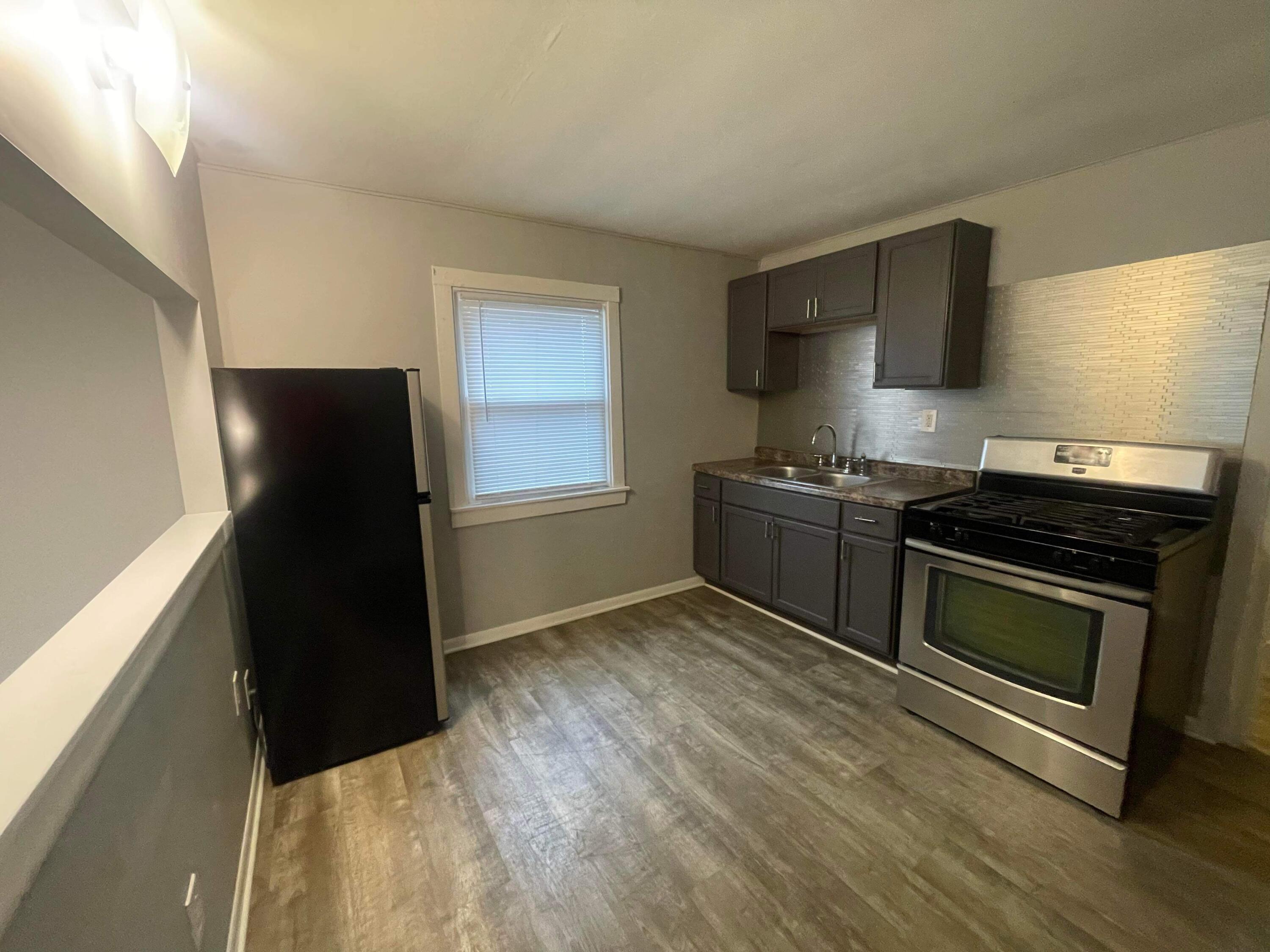 140 North West Street Crown Point, IN 46307 - Photo 6 of 15 a kitchen with granite countertop a refrigerator stove and sink
