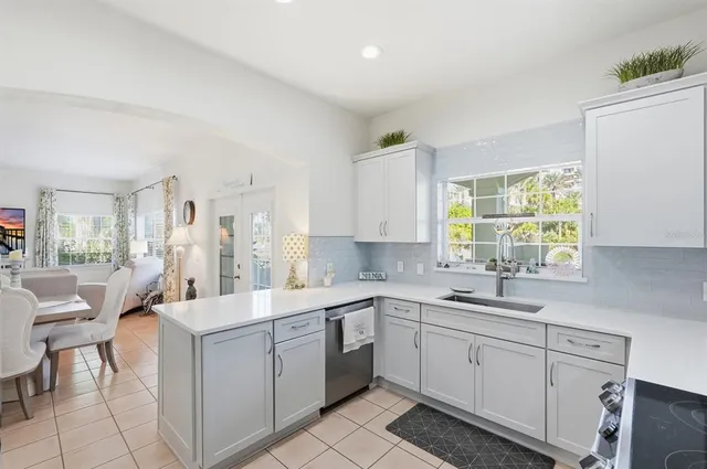 a bathroom with a granite countertop sink a mirror and a picture